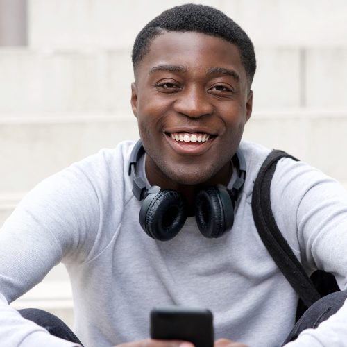 cool-young-black-man-smiling-with-cellphone-and-he-2021-08-29-08-18-54-utc.jpg